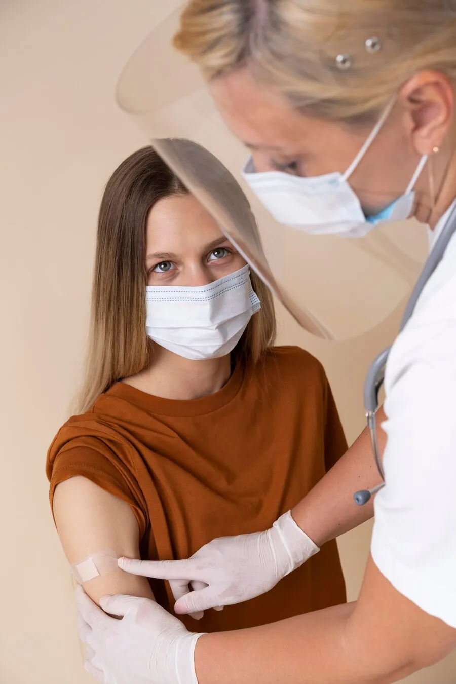 woman-with-medical-mask-getting-sticker-arm-after-getting-vaccine_23-2149014333
